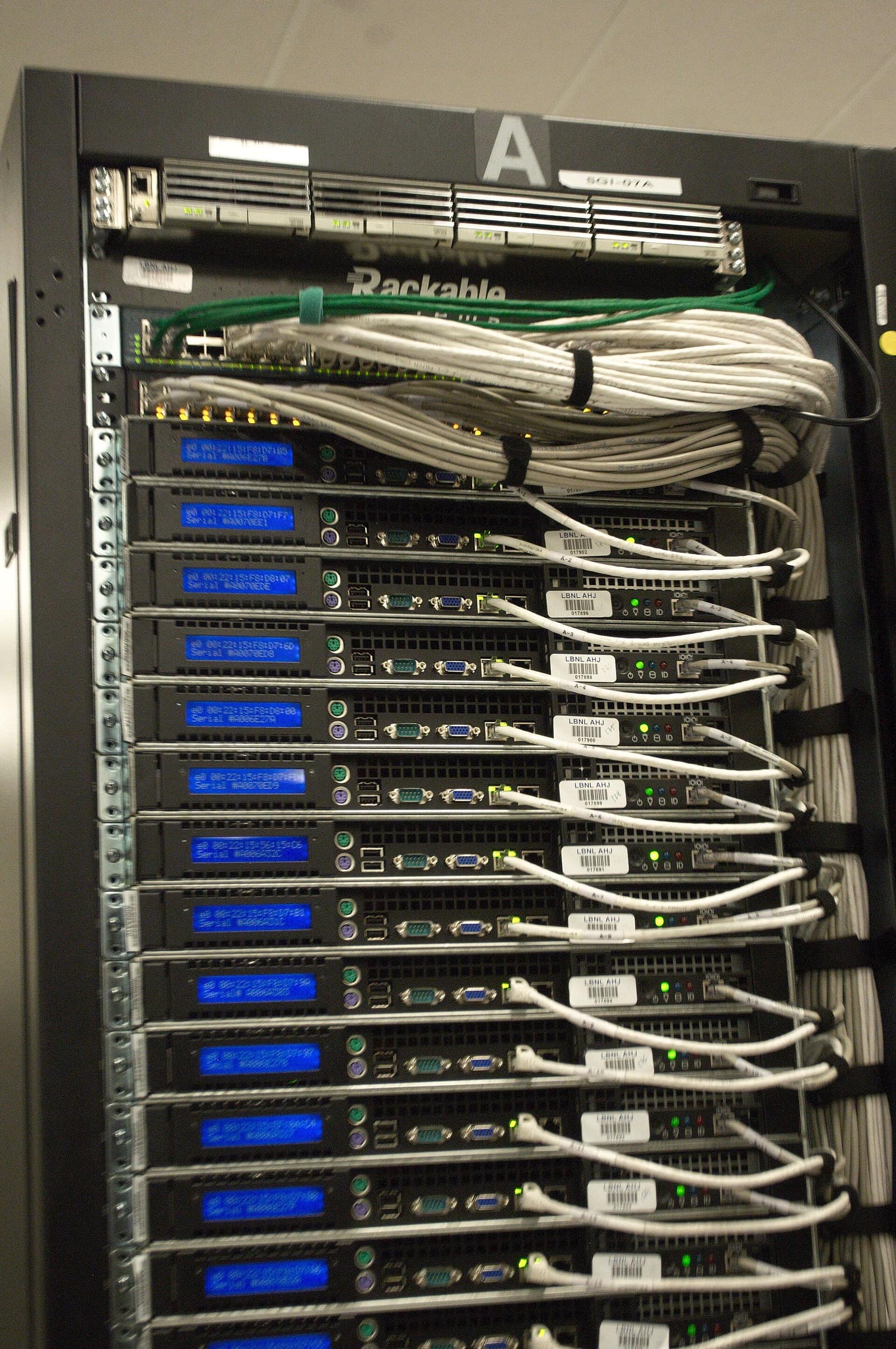 The back of a server rack: a column of 1U servers, each with its cables tied to the right